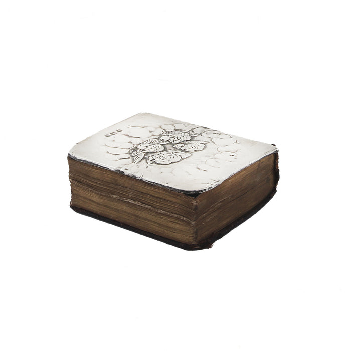 a miniature antique hymn book with silver cherub cover
