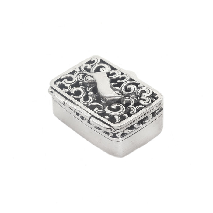 a rectangular silver box with swirls