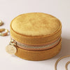 mustard velvet round zipped jewellery travel case with floral design inside