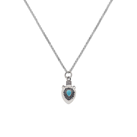 a small detailed perfume bottle with a turquoise stone pendant on a silver chain